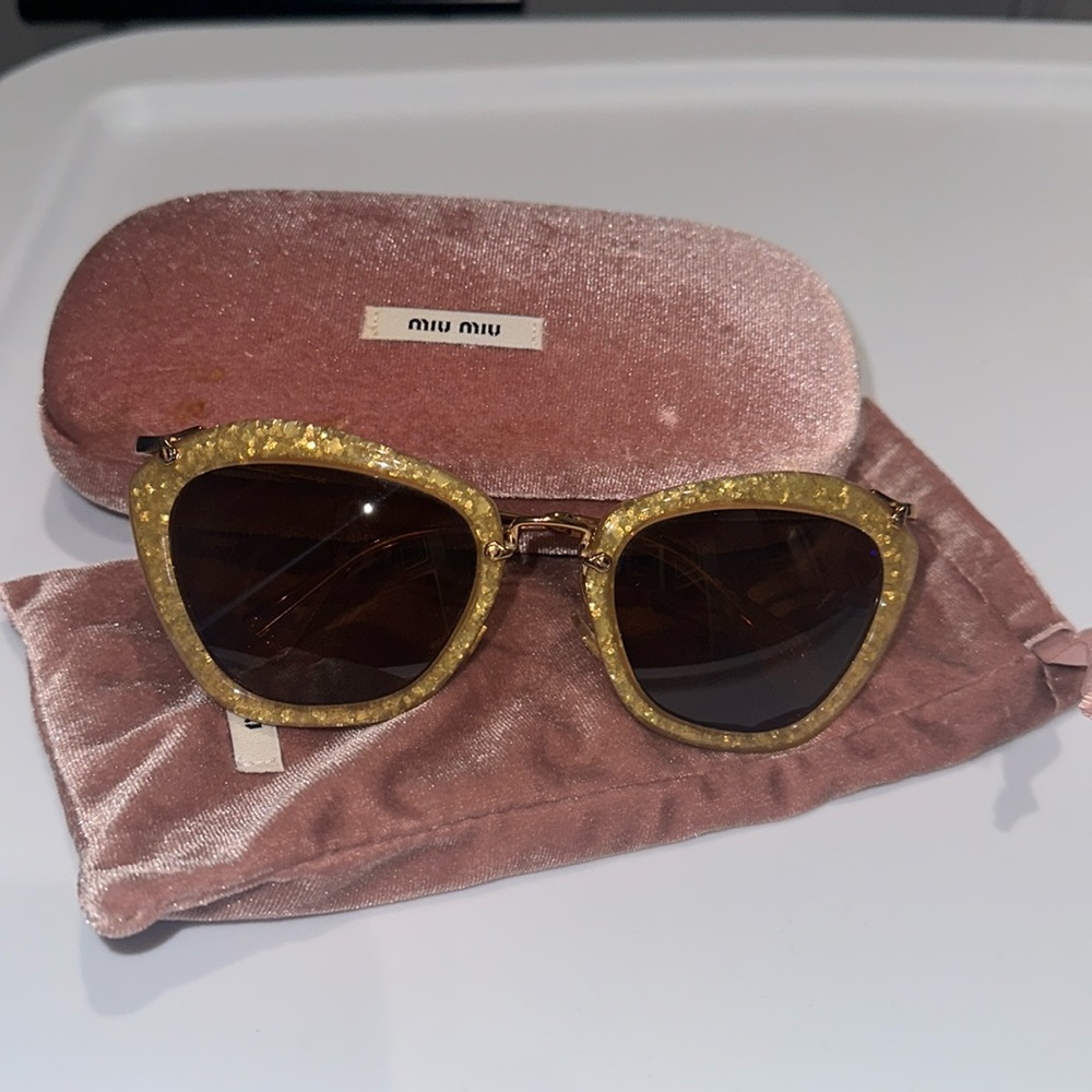 Gold Miu Miu sunglasses